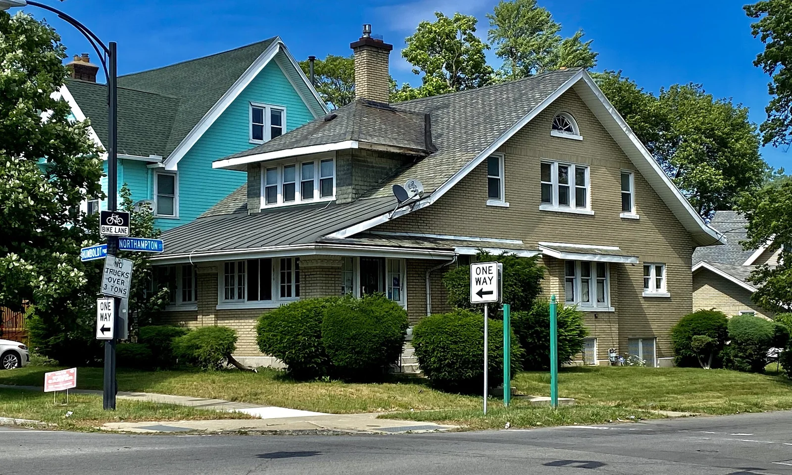 Two neighboring houses with porches and pitched roofs in Buffalo, New York